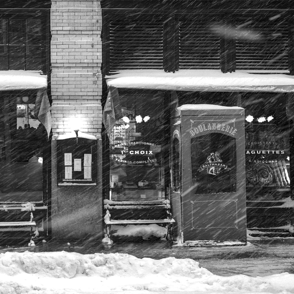 Snowy Stroll by Balthazar  Trevor Little   Black and white photograph of the restaurant Balthazar on a snowy day