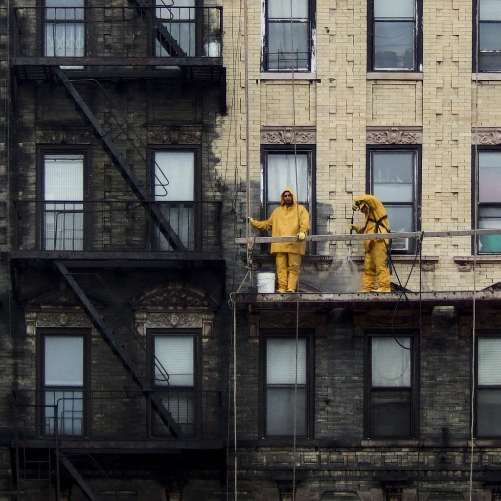 Power Washing at 188 Suffolk Street  Trevor Little   Photograph of window washers. Calming color palette with dark grays and beige and subtle pops of yellow. Photo taken on Lower East Side. 